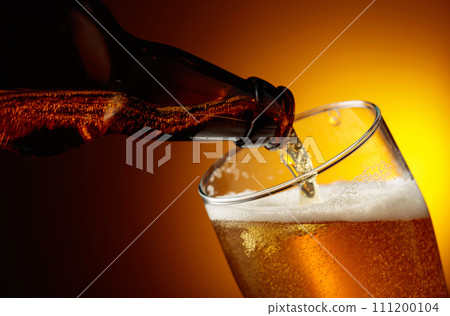 Pouring beer from a bottle into a glass. 111200104
