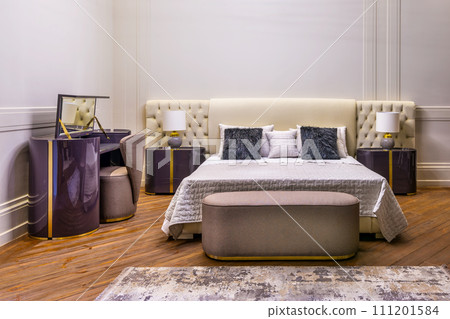 Bedroom with tufted headboard bed, dresser, and nightstands lamps on Bedroom with tufted headboard bed, dresser, and nightstands lamps on 111201584