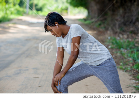 Slim sporty woman doing warm-up outdoors in the park. Slim sporty woman doing warm-up outdoors in the park. 111201879