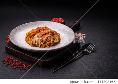 Delicious asian udon dish with vegetables, mushrooms, salt and spices 111202467