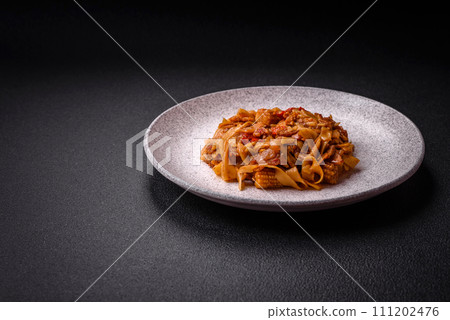 Delicious asian udon dish with vegetables, mushrooms, salt and spices Delicious asian udon dish with vegetables, mushrooms, salt and spices 111202476