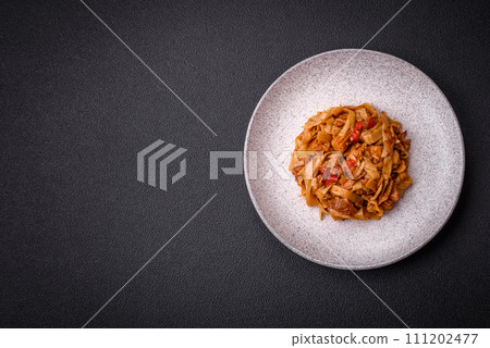 Delicious asian udon dish with vegetables, mushrooms, salt and spices 111202477