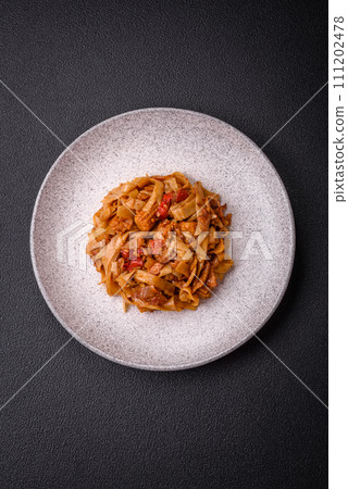 Delicious asian udon dish with vegetables, mushrooms, salt and spices Delicious asian udon dish with vegetables, mushrooms, salt and spices 111202478