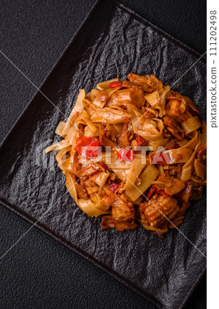 Delicious asian udon dish with vegetables, mushrooms, salt and spices 111202498