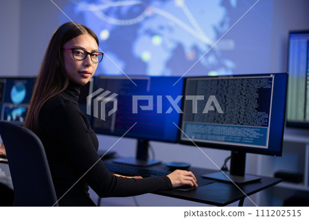 Female IT Consultant in cyber security team working to prevent security threats, find vulnerability and solve incidents 111202515