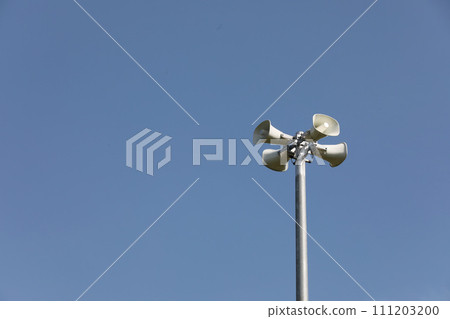 Whire horn speaker in the park with clear blue sky background.. Whire horn speaker in the park with clear blue sky background.. 111203200