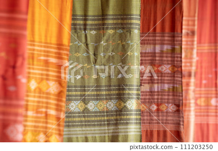 Colorful Tai Lue woven fabric from northern of Thailand. (Selective focus). Colorful Tai Lue woven fabric from northern of Thailand. (Selective focus). 111203250