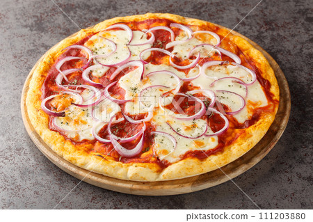 Delicious and spicy pizza Pugliese made of tomatoes, cheese, red onion and oregano closeup on the wooden board. Horizontal 111203880