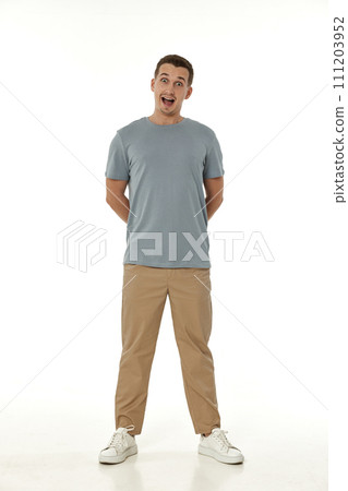 surprised guy looking at camera on white studio background 111203952