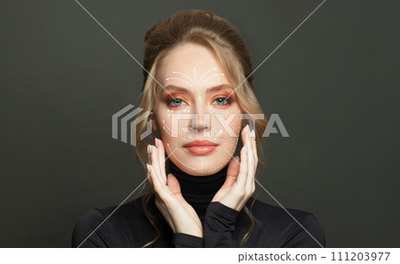 Young attractive woman with white arrows over face. Anti aging treatment and plastic surgery concept Young attractive woman with white arrows over face. Anti aging treatment and plastic surgery concept 111203977