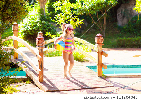 Child in swimming pool with ball. Kids swim. Child in swimming pool with ball. Kids swim. 111204045