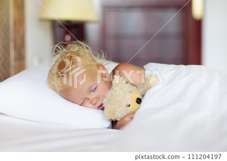 Baby boy sleeping in white bed Baby boy sleeping in white bed 111204197