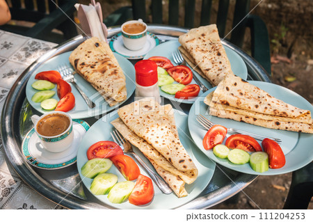 Turkish breakfast with savory pastry Gozleme served outdoor Turkish breakfast with savory pastry Gozleme served outdoor 111204253