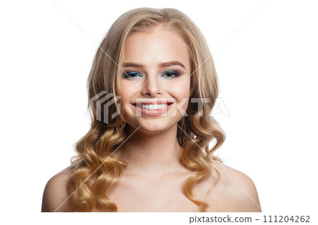 Excited young woman with clean fresh skin and long curly hair looking at camera Excited young woman with clean fresh skin and long curly hair looking at camera 111204262
