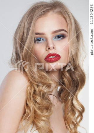 Stylish healthy blonde model posing isolated on white background. Woman with make-up 111204288