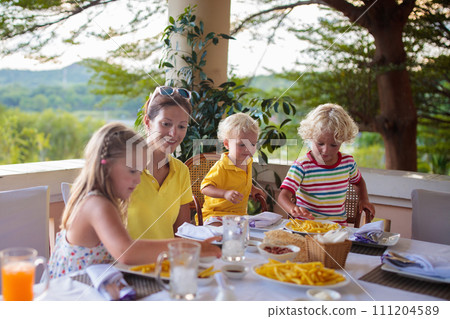 Family having dinner on outdoor patio. 111204589