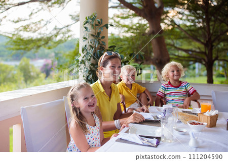 Family having dinner on outdoor patio. 111204590