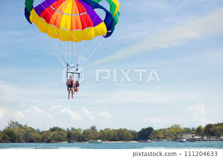 Kids parasailing. Water sport on summer vacation. Kids parasailing. Water sport on summer vacation. 111204633