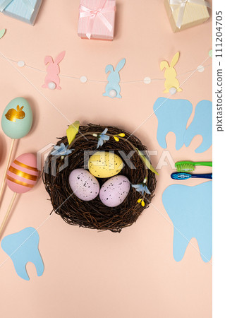 Easter dentistry nest with colorful eggs and teeth top view Easter dentistry nest with colorful eggs and teeth top view 111204705
