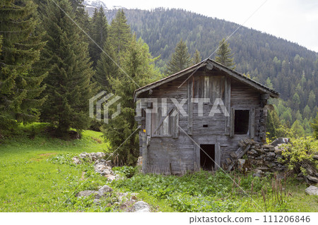 Wooden shed in Binnatal in the Swiss Alps along a mountain trail 111206846