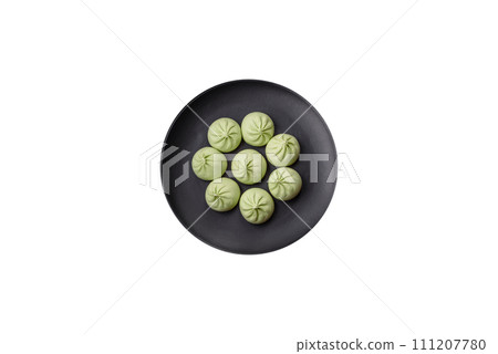 Raw khinkali or green dumplings with salt, spices and herbs Raw khinkali or green dumplings with salt, spices and herbs 111207780