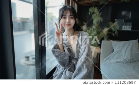 young woman in bathrobe 111208697