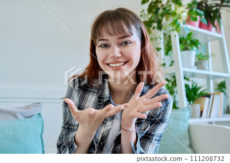 Web camera view of teenage girl talking looking in camera, online meeting, video call Web camera view of teenage girl talking looking in camera, online meeting, video call 111208732