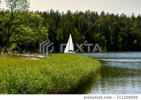 Sailing yacht cruising on the lake in Sweden. Tourism sailing boat. 111208899