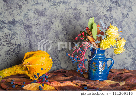 an autumn composition consisting of chrysanthemums, pumpkins, autumn leaves and chestnuts, kaki 111209116