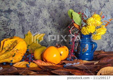 an autumn composition consisting of chrysanthemums, pumpkins, autumn leaves and chestnuts, kaki 111209117