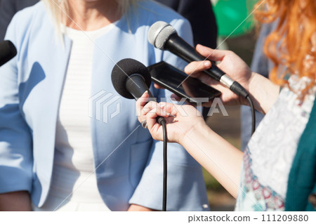 Reporters making media interview with business woman or female politician Reporters making media interview with business woman or female politician 111209880