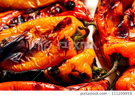 Red roasted kapia paprika on a ceramic plate. Red roasted kapia paprika on a ceramic plate. 111209959