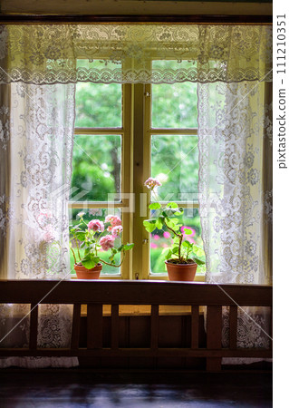 flowers in the window of a beautiful building flowers in the window of a beautiful building 111210351
