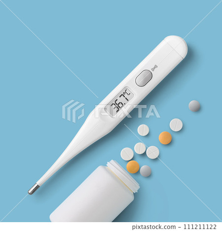 Electronic thermometer and pills on blue background directly above 111211122