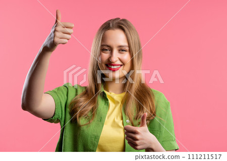 Stylish woman with hand sign like, thumbs up gesture. Lady on pink background Stylish woman with hand sign like, thumbs up gesture. Lady on pink background 111211517