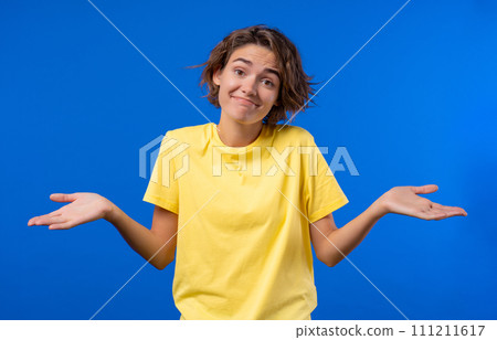 Confused pretty woman, shoulders up - can't help, makes gesture of I dont know.  111211617