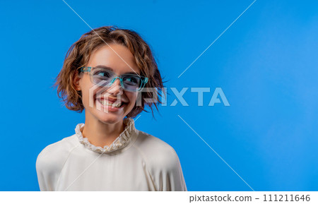 Smiling woman in transparent blue glasses. Positive stylish lady copy space. 111211646