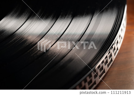 Classic vinyl record, turntable spin, analog sound, music. Vintage aesthetics. Classic vinyl record, turntable spin, analog sound, music. Vintage aesthetics. 111211913