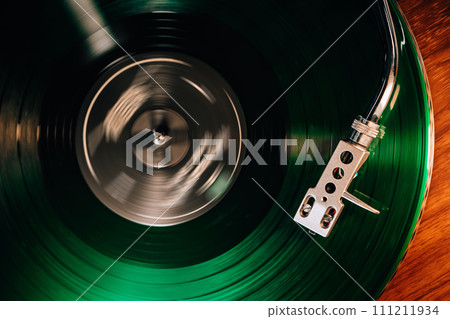 Classic vinyl record, turntable spin, analog sound, music concept. Retro vibes. Classic vinyl record, turntable spin, analog sound, music concept. Retro vibes. 111211934