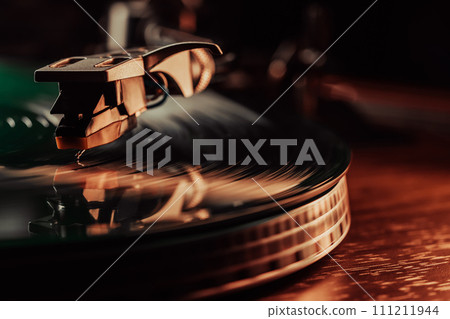 Classic vinyl record, turntable spin, analog sound, music. Vintage aesthetics. 111211944