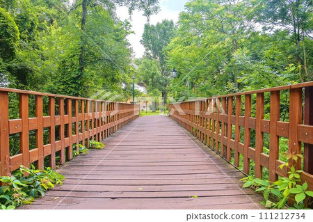 Old wooden bridge in town, natural vintage background Old wooden bridge in town, natural vintage background 111212734