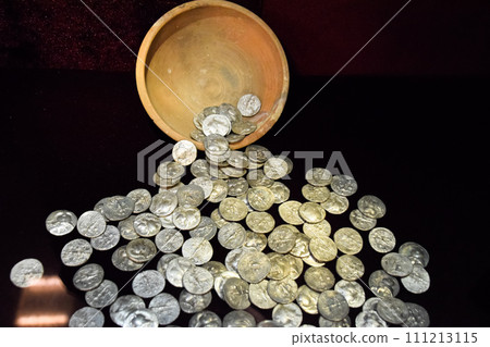 Silver coins poured out of clay pot 111213115