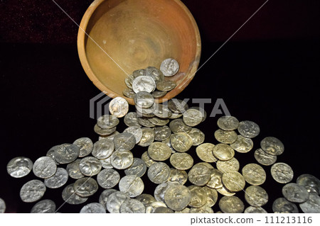 Silver coins poured out of clay pot Silver coins poured out of clay pot 111213116