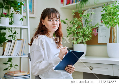 Young female teenager with digital tablet, stylus drawing illustrating sitting at home Young female teenager with digital tablet, stylus drawing illustrating sitting at home 111213227