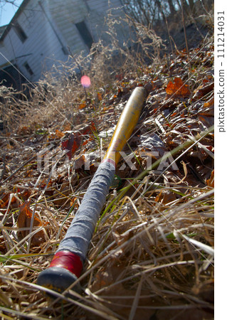 Vintage Baseball Bat on Autumn Field with Abandoned Building Background 111214031