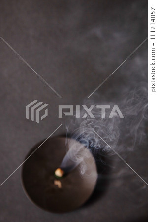 Meditative Glow of Incense Ember with Rising Smoke Patterns Meditative Glow of Incense Ember with Rising Smoke Patterns 111214057