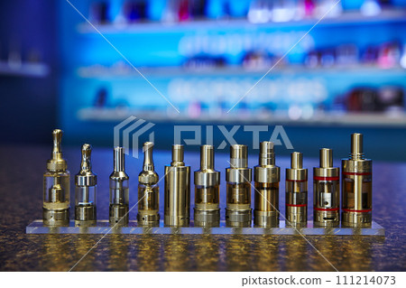 Low Angle View of E-Cigarette Atomizers in Nightlife Setting 111214073