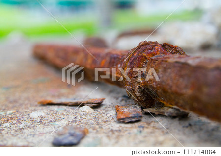 Close-Up of Rusted Metal Rod on Concrete in Urban Outdoors 111214084