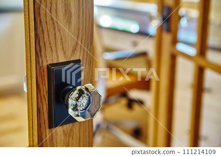 Elegant Wooden Door with Glass Knob, Warm Interior Bokeh 111214109