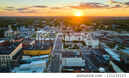 Downtown aerial of Muncie, IN city with golden sun setting on horizon Downtown aerial of Muncie, IN city with golden sun setting on horizon 111214123